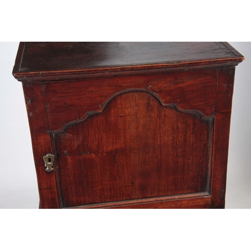 1142 - AN EARLY 18TH CENTURY WALNUT SPICE CUPBOARD ON CHEST having a shaped panelled top door revealing a b... 