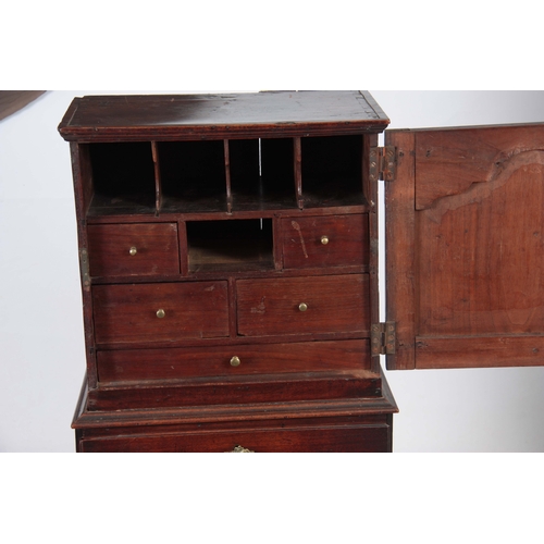 1142 - AN EARLY 18TH CENTURY WALNUT SPICE CUPBOARD ON CHEST having a shaped panelled top door revealing a b... 