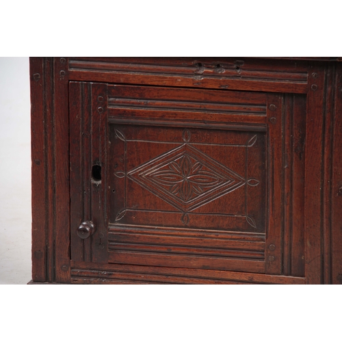 1143 - AN EARLY 18TH CENTURY OAK HANGING FOOD HUTCH with a hinged door having a lozenge-shaped carved panel... 