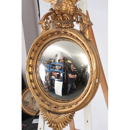 1147 - AN IMPRESSIVE REGENCY CONVEX CARVED GILT GESSO MIRROR OF LARGE SCALE having a 22