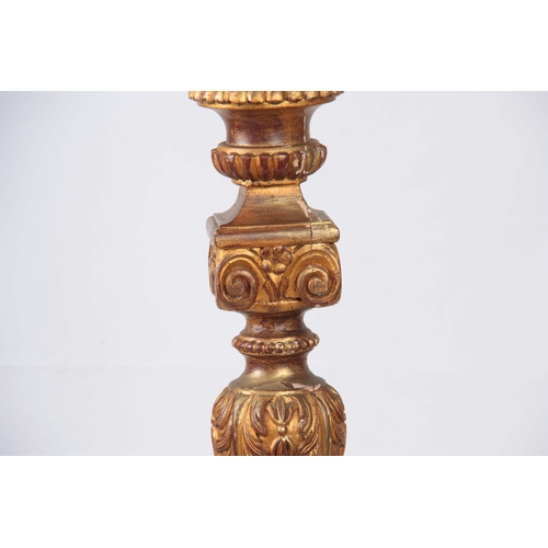 1148 - A LARGE 19th CENTURY CARVED GILT GESSO TORCHERE with acanthus leaf tapering stem supported on a   sc... 