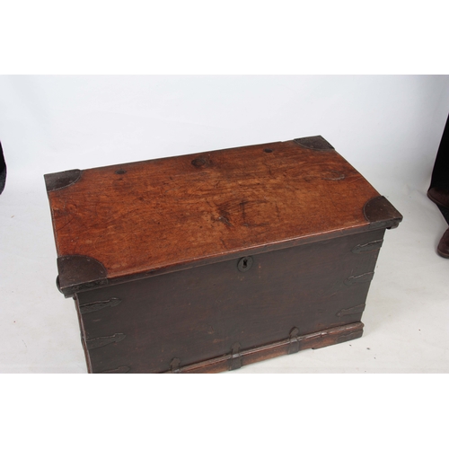 1151 - AN 18TH CENTURY WALNUT OFFICERS TRUNK with iron mounted corners and strapped sides with carrying han... 