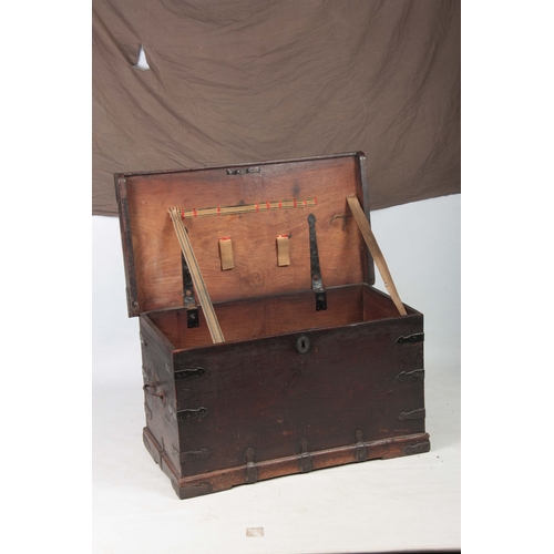 1151 - AN 18TH CENTURY WALNUT OFFICERS TRUNK with iron mounted corners and strapped sides with carrying han... 