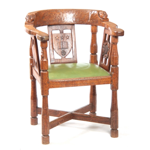 1154 - AN EARLY  ROBERT 'MOUSEMAN' THOMPSON OAK MONKS CHAIR with hooped arms and carved masks to the backre... 