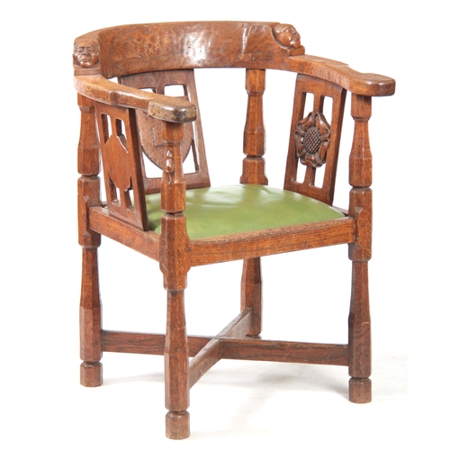 1154 - AN EARLY  ROBERT 'MOUSEMAN' THOMPSON OAK MONKS CHAIR with hooped arms and carved masks to the backre... 