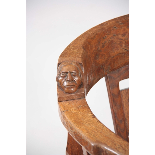 1154 - AN EARLY  ROBERT 'MOUSEMAN' THOMPSON OAK MONKS CHAIR with hooped arms and carved masks to the backre... 