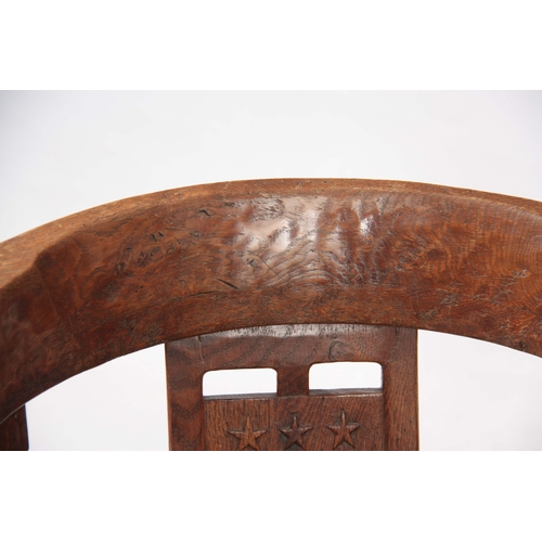 1154 - AN EARLY  ROBERT 'MOUSEMAN' THOMPSON OAK MONKS CHAIR with hooped arms and carved masks to the backre... 