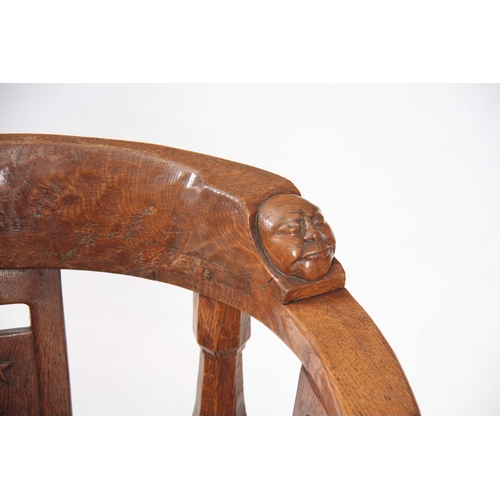 1154 - AN EARLY  ROBERT 'MOUSEMAN' THOMPSON OAK MONKS CHAIR with hooped arms and carved masks to the backre... 