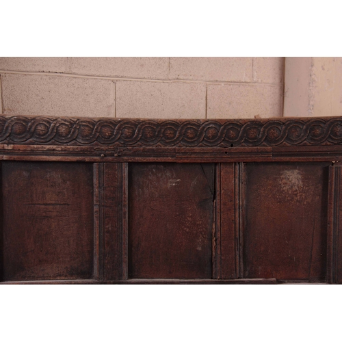 1159 - A RARE OVERSIZED 17TH CENTURY AND LATER JOINED OAK BOX SETTLE with an arcaded carved top rail, panel... 