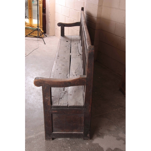 1159 - A RARE OVERSIZED 17TH CENTURY AND LATER JOINED OAK BOX SETTLE with an arcaded carved top rail, panel... 