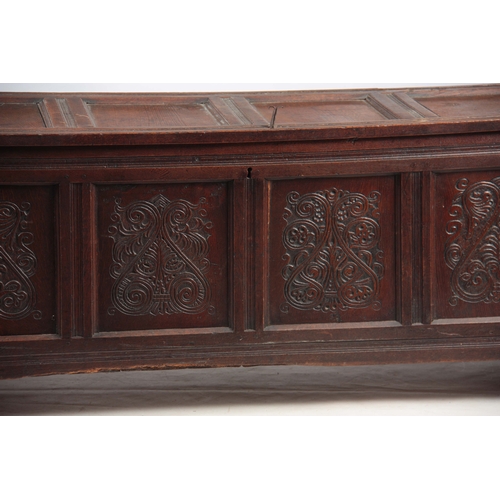 1160 - A 17TH CENTURY JOINED OAK FOUR PLANK WESTMORELAND COFFER with hinged lid above four carved scrolled ... 