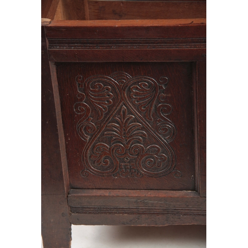 1160 - A 17TH CENTURY JOINED OAK FOUR PLANK WESTMORELAND COFFER with hinged lid above four carved scrolled ... 