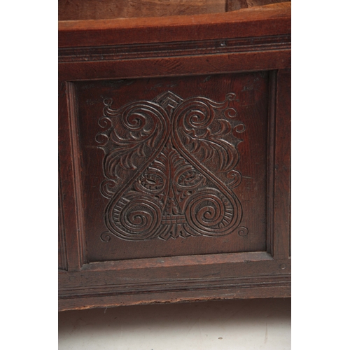 1160 - A 17TH CENTURY JOINED OAK FOUR PLANK WESTMORELAND COFFER with hinged lid above four carved scrolled ... 