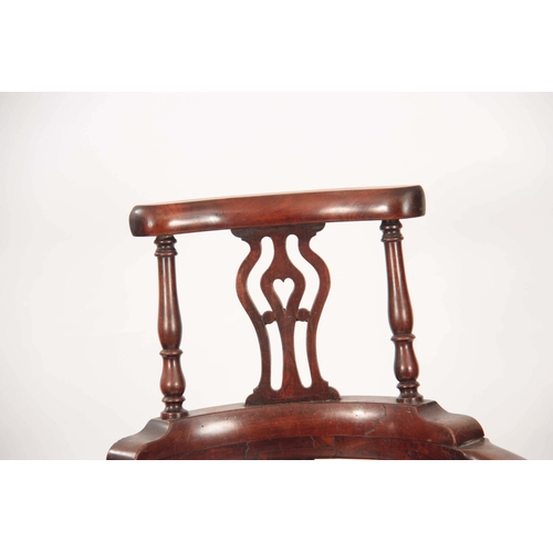 1170 - A GEORGE II WALNUT CORNER CHAIR with shaped back having pierced back splats raised by turned support... 