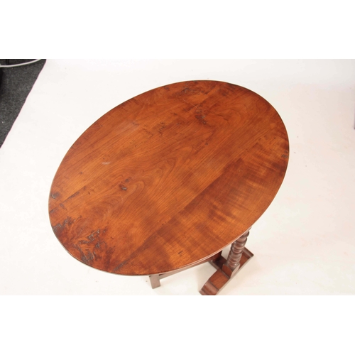 1173 - AN 18TH CENTURY CHERRY WOOD FOLDING COACHING TABLE with oval plank top above a ring turned hinged ba... 