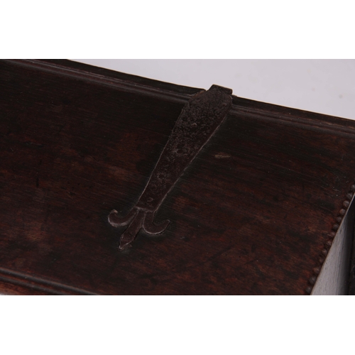 1177 - A 17TH CENTURY OAK PLANK COFFER / SWORD BOX OF LARGE SIZE with moulded edge hinged top fitted with s... 