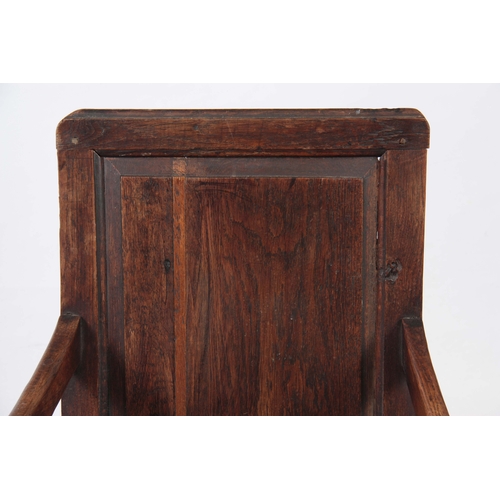 1180 - AN EARLY 18TH CENTURY OAK WAINSCOT CHAIR having fielded panel back with open arms and turned support... 