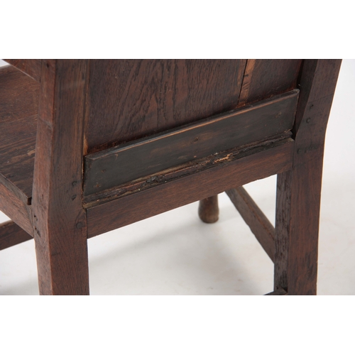 1180 - AN EARLY 18TH CENTURY OAK WAINSCOT CHAIR having fielded panel back with open arms and turned support... 