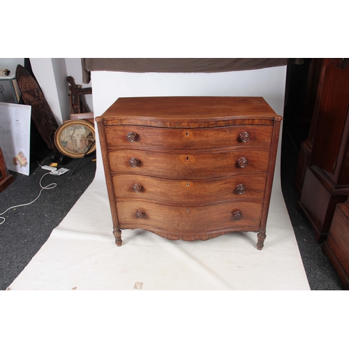 1181 - A GEORGE III MAHOGANY SERPENTINE CHEST OF DRAWERS having four long graduated drawers fitted with tur... 