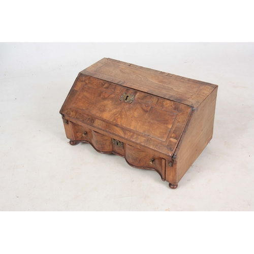 946 - AN EARLY 18TH CENTURY WALNUT TABLE TOP BUREAU / WRITING BOX with angled fall revealing a fitted inte... 