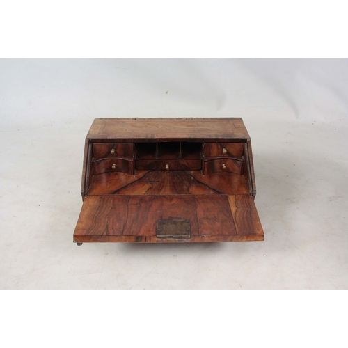 946 - AN EARLY 18TH CENTURY WALNUT TABLE TOP BUREAU / WRITING BOX with angled fall revealing a fitted inte... 