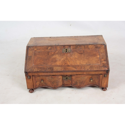 946 - AN EARLY 18TH CENTURY WALNUT TABLE TOP BUREAU / WRITING BOX with angled fall revealing a fitted inte... 