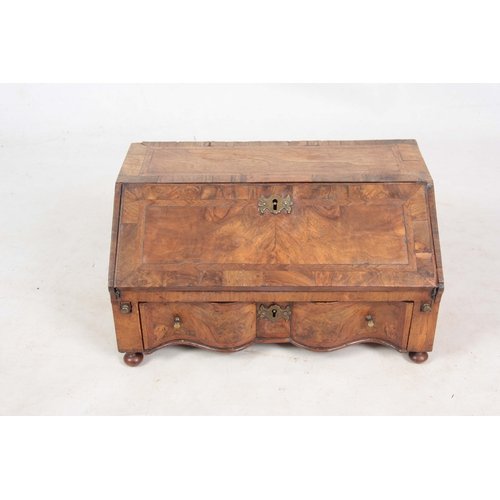 946 - AN EARLY 18TH CENTURY WALNUT TABLE TOP BUREAU / WRITING BOX with angled fall revealing a fitted inte... 