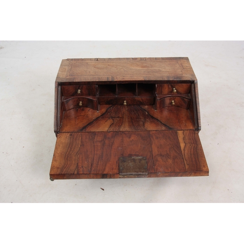 946 - AN EARLY 18TH CENTURY WALNUT TABLE TOP BUREAU / WRITING BOX with angled fall revealing a fitted inte... 