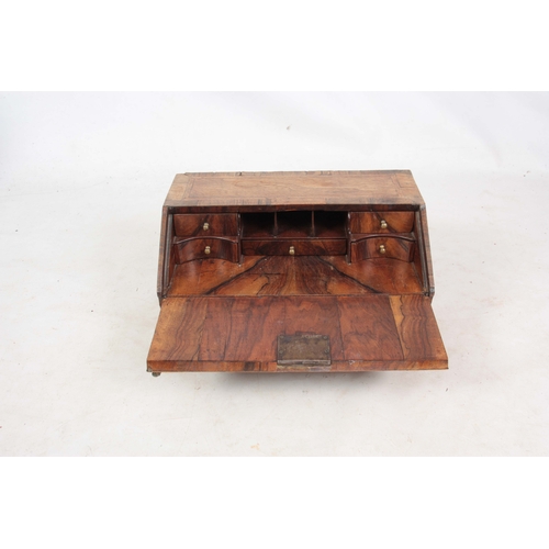 946 - AN EARLY 18TH CENTURY WALNUT TABLE TOP BUREAU / WRITING BOX with angled fall revealing a fitted inte... 