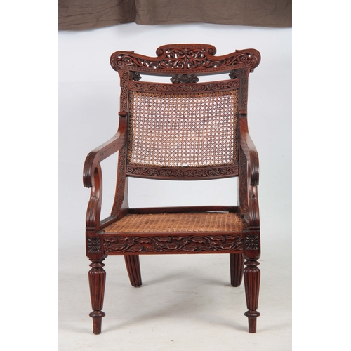 1190 - AN ANGLO INDIAN ROSEWOOD BERGERE ARMCHAIR having a reclining back, with pierced shaped headrest abov... 