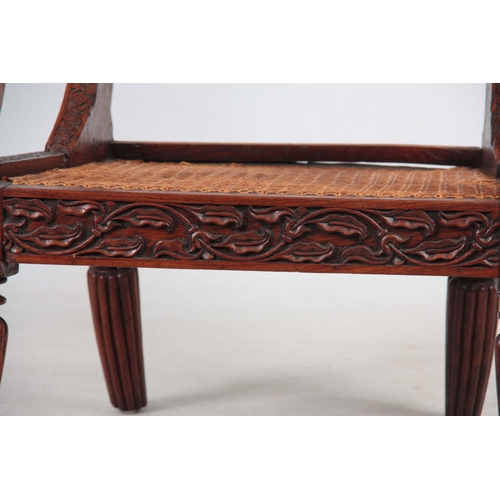 1190 - AN ANGLO INDIAN ROSEWOOD BERGERE ARMCHAIR having a reclining back, with pierced shaped headrest abov... 