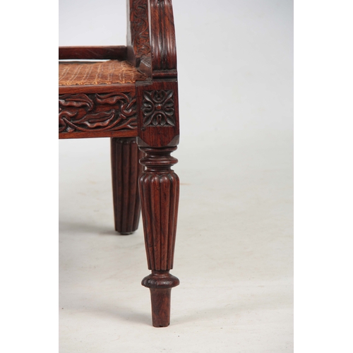 1190 - AN ANGLO INDIAN ROSEWOOD BERGERE ARMCHAIR having a reclining back, with pierced shaped headrest abov... 