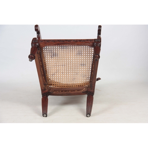 1190 - AN ANGLO INDIAN ROSEWOOD BERGERE ARMCHAIR having a reclining back, with pierced shaped headrest abov... 