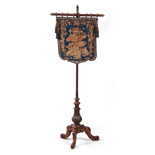 1191 - AN EARLY VICTORIAN WALNUT POLE SCREEN with blue ground floral needlework panel on a rise and fall tu... 