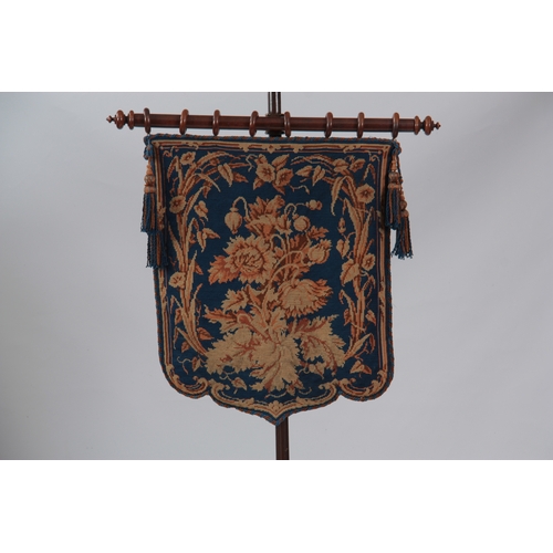 1191 - AN EARLY VICTORIAN WALNUT POLE SCREEN with blue ground floral needlework panel on a rise and fall tu... 