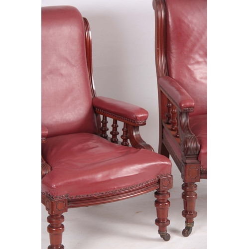 1194 - A PAIR OF LATE 19TH CENTURY MAHOGANY RED LEATHERED ARMCHAIRS with shaped backs and open arms support... 