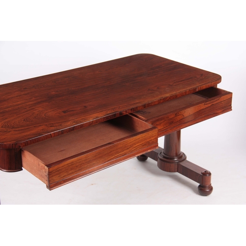 1195 - A WILLIAM IV ROSEWOOD LIBRARY TABLE with rounded corners above two frieze drawers; standing on turne... 