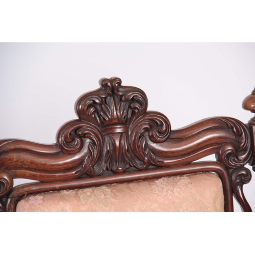 1197 - A MID VICTORIAN ROSEWOOD UPHOLSTERED ROSEWOOD NURSING CHAIR with leaf carved top rail, barley twist ... 