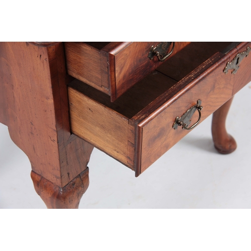 1198 - AN 18TH CENTURY FIGURED WALNUT LOWBOY with three drawers fitted with shaped brass handles; standing ... 