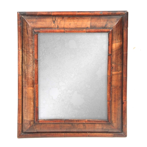 1207 - A 19TH CENTURY WILLIAM AND MARY STYLE WALNUT CUSHION FRAMED HANGING MIRROR  with cross-grained mould... 