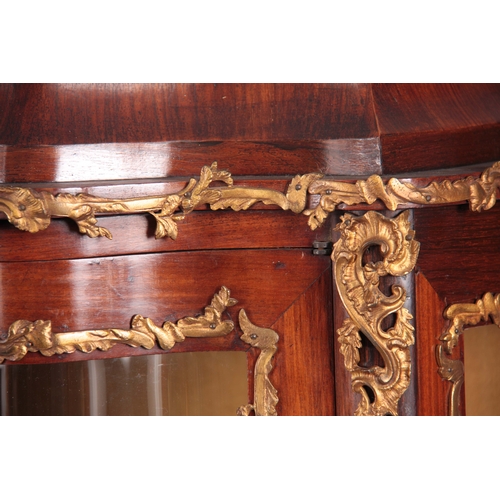 1215 - A 19TH CENTURY FRENCH ROSEWOOD, WALNUT AND MARQUETRY INLAID DOUBLE SERPENTINE FRONTED VITRINE WITH L... 