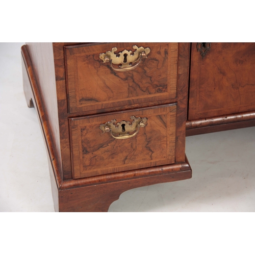 1227 - A GEORGE I HERRING-BANDED BURR WALNUT KNEEHOLE DESK with moulded edge top and rounded corners above ... 