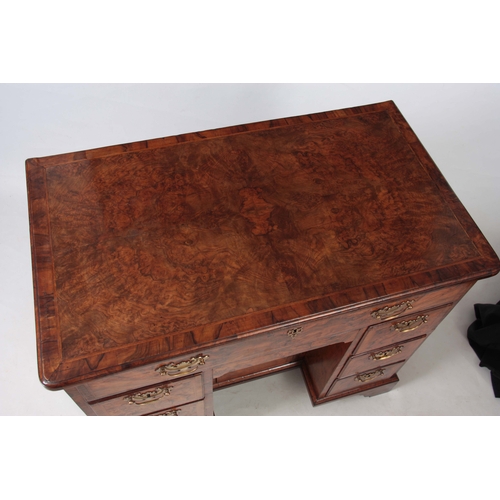 1227 - A GEORGE I HERRING-BANDED BURR WALNUT KNEEHOLE DESK with moulded edge top and rounded corners above ... 