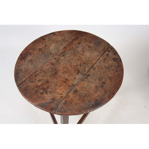 1229 - AN 18TH CENTURY OAK CRICKET TABLE with three plank circular top above a tripod base with tapering le... 