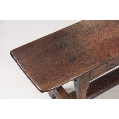 1241 - A RARE 17TH CENTURY JOINED OAK BENCH with single plank top above angled ringed turned legs united by... 