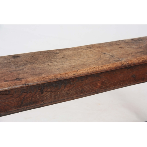 1241 - A RARE 17TH CENTURY JOINED OAK BENCH with single plank top above angled ringed turned legs united by... 