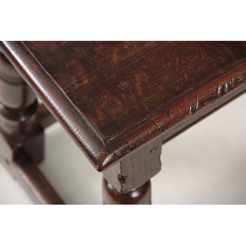 1242 - A LATE 17th CENTURY OAK JOINT STOOL with pegged moulded edge top above bulbous ring-turned legs join... 