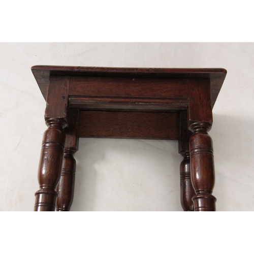 1242 - A LATE 17th CENTURY OAK JOINT STOOL with pegged moulded edge top above bulbous ring-turned legs join... 