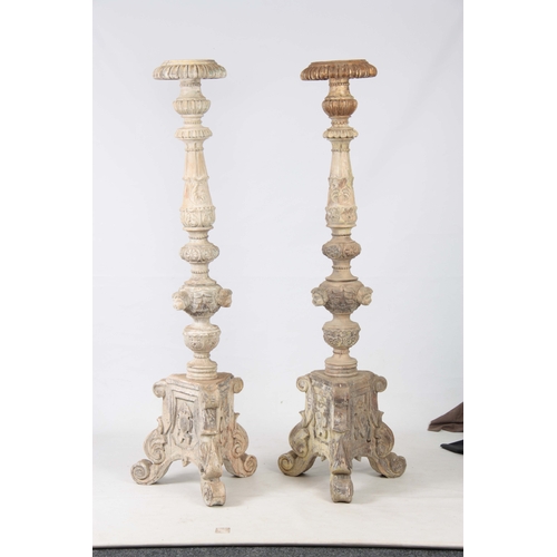 1243 - A LARGE PAIR OF CONTINENTAL CARVED PAINTED TORCHERES having acanthus leaf and gadrooned stems with c... 