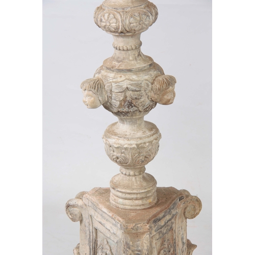 1243 - A LARGE PAIR OF CONTINENTAL CARVED PAINTED TORCHERES having acanthus leaf and gadrooned stems with c... 